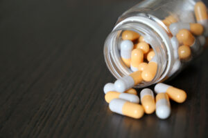 Pills on a dark wooden table