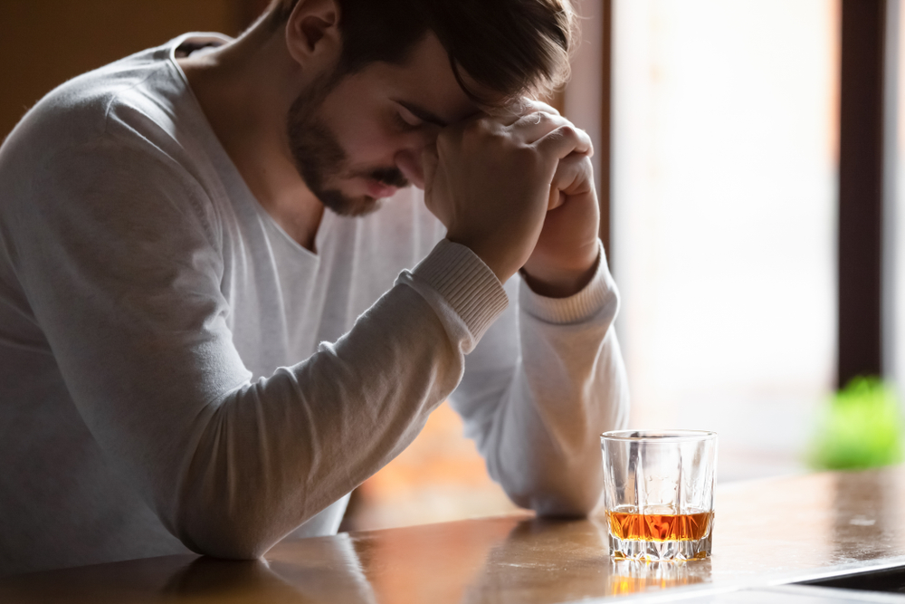depressed man drinking alcohol