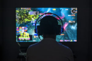 gamer wearing headset playing pc game