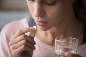 woman taking a prescription pill